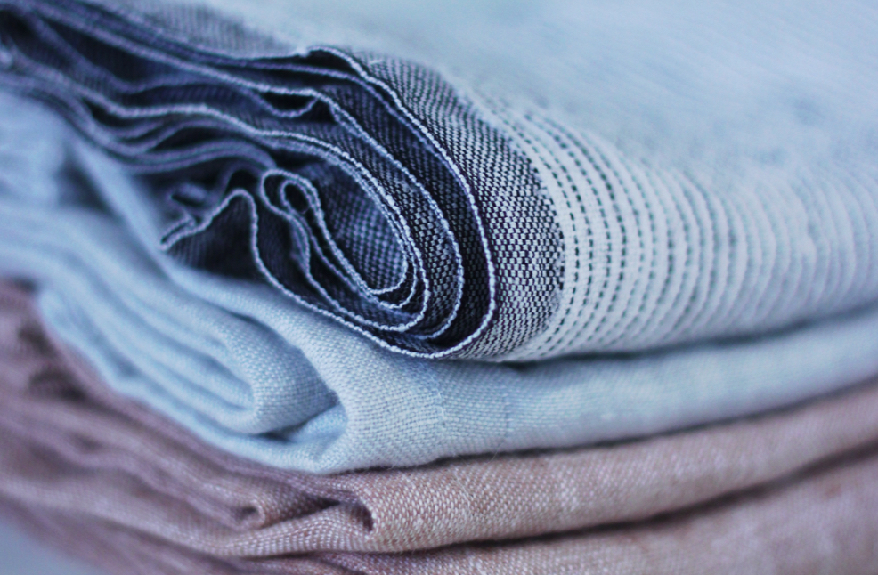 Folded linens in shades of blue and mauve